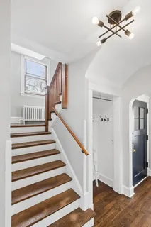 a bathroom with a bathtub and a picture on the wall