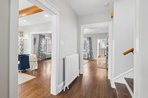 a living room with furniture and wooden floor