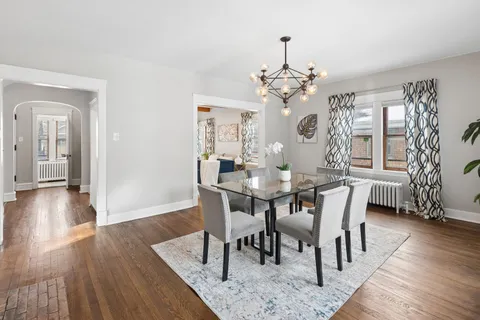 a view of a dining room with furniture wooden floor and chandelier