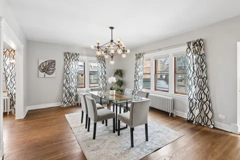a view of a dining room with furniture wooden floor and a chandelier