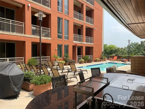 a view of a patio with a dining table and chairs
