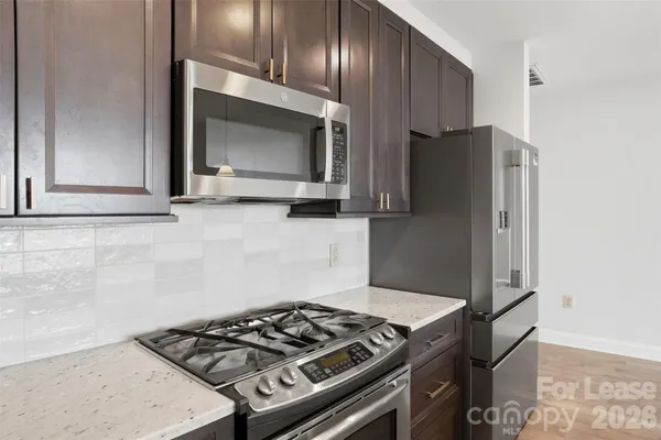 a kitchen with wooden cabinets and a stove top oven