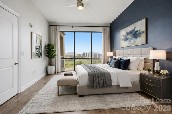 a bedroom with bed and glass window