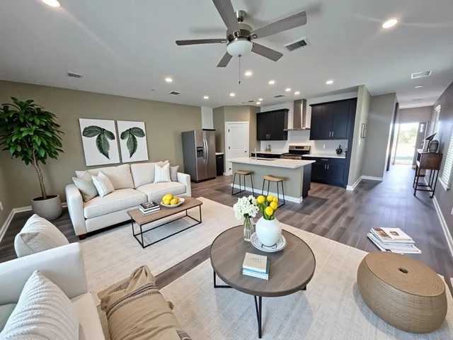a living room with furniture kitchen and a table