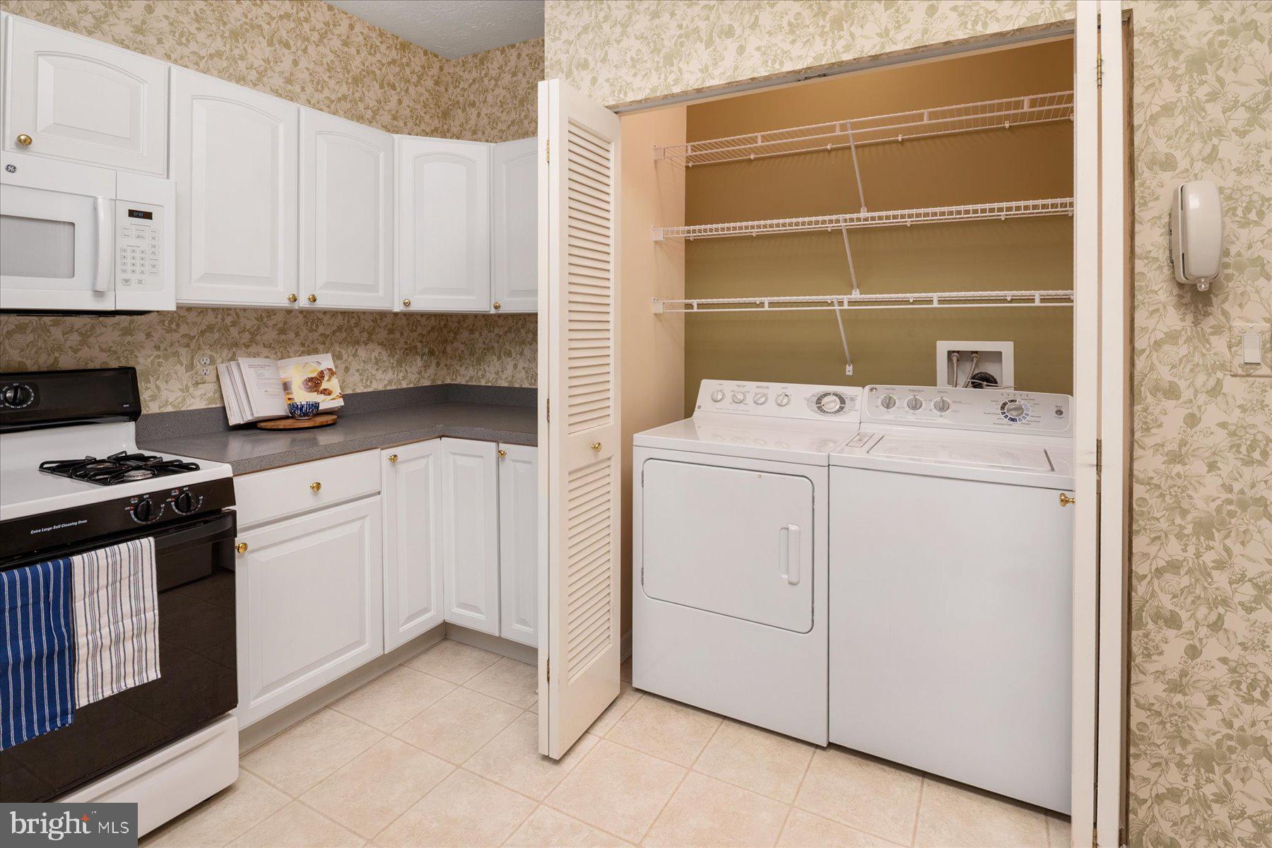 2502 Amber Orchard Court West, Unit 104 Odenton, MD 21113 - Photo 12 of 28 a kitchen with granite countertop white cabinets and white appliances