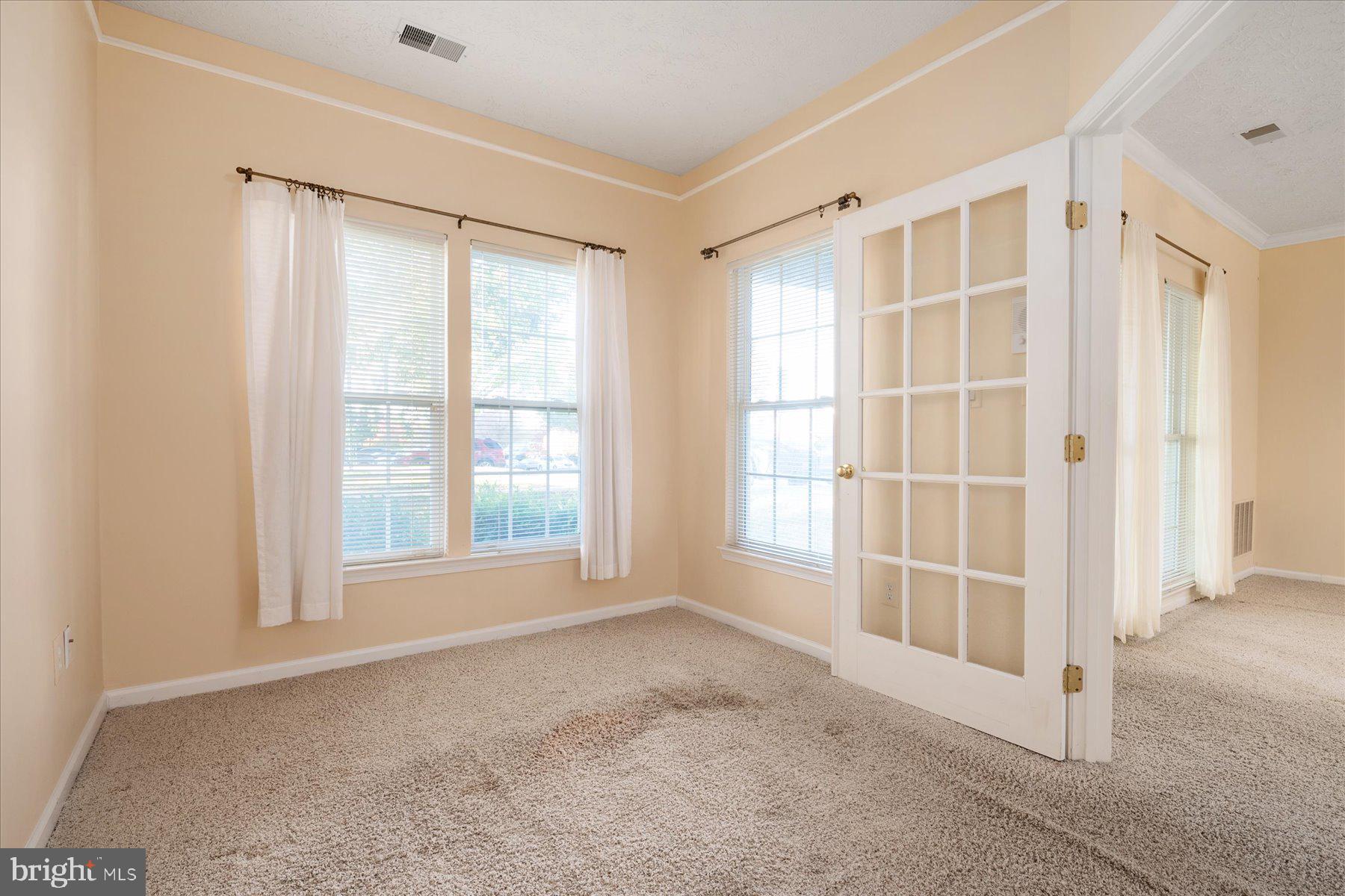 2502 Amber Orchard Court West, Unit 104 Odenton, MD 21113 - Photo 13 of 28 an empty room with windows
