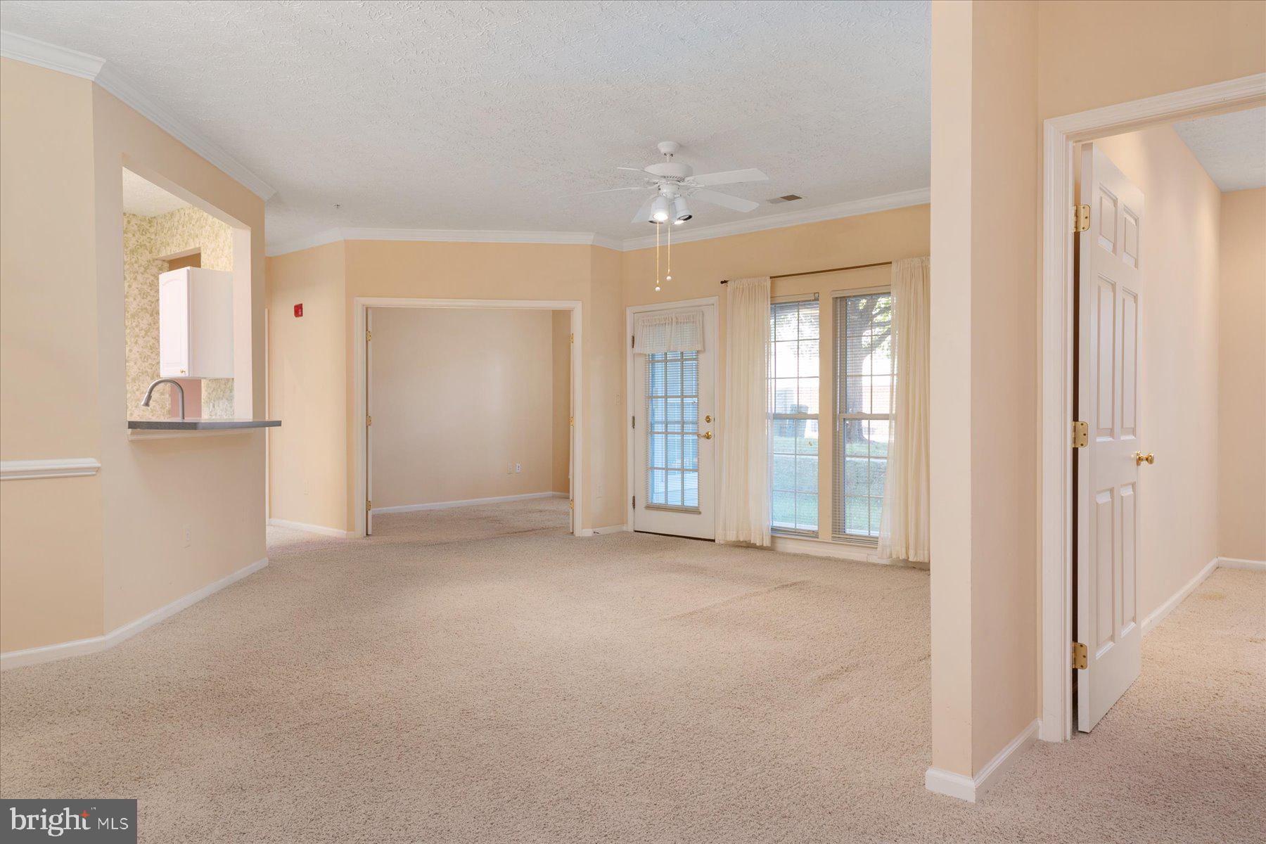 2502 Amber Orchard Court West, Unit 104 Odenton, MD 21113 - Photo 3 of 28 wooden floor in an empty room with a window