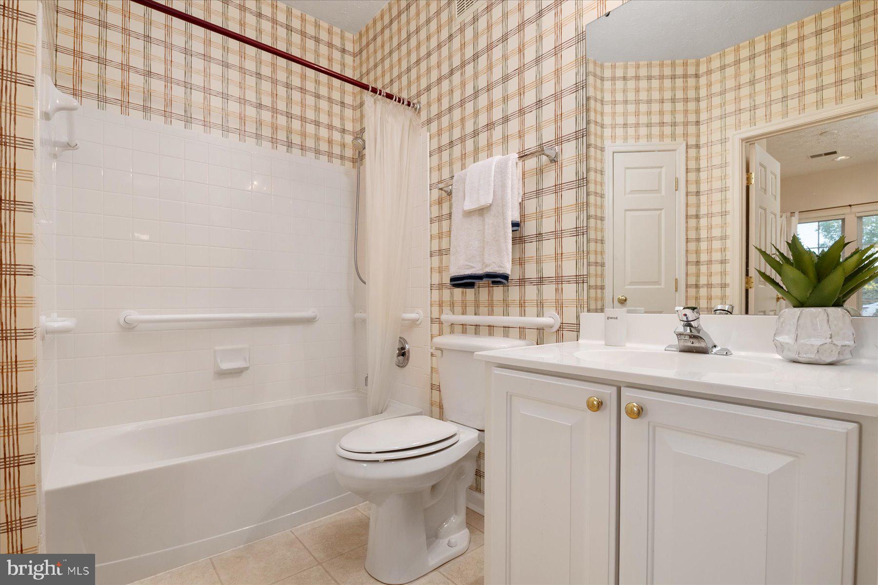 2502 Amber Orchard Court West, Unit 104 Odenton, MD 21113 - Photo 8 of 28 a bathroom with a sink a toilet and shower