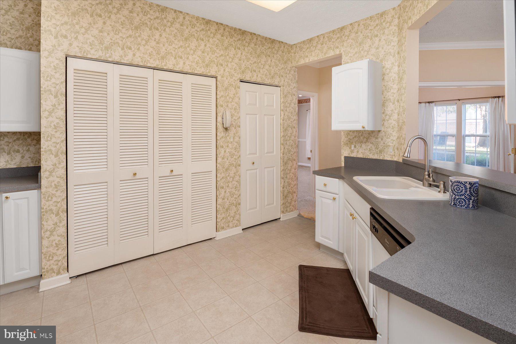 2502 Amber Orchard Court West, Unit 104 Odenton, MD 21113 - Photo 10 of 28 a spacious bathroom with a granite countertop sink and a bathtub