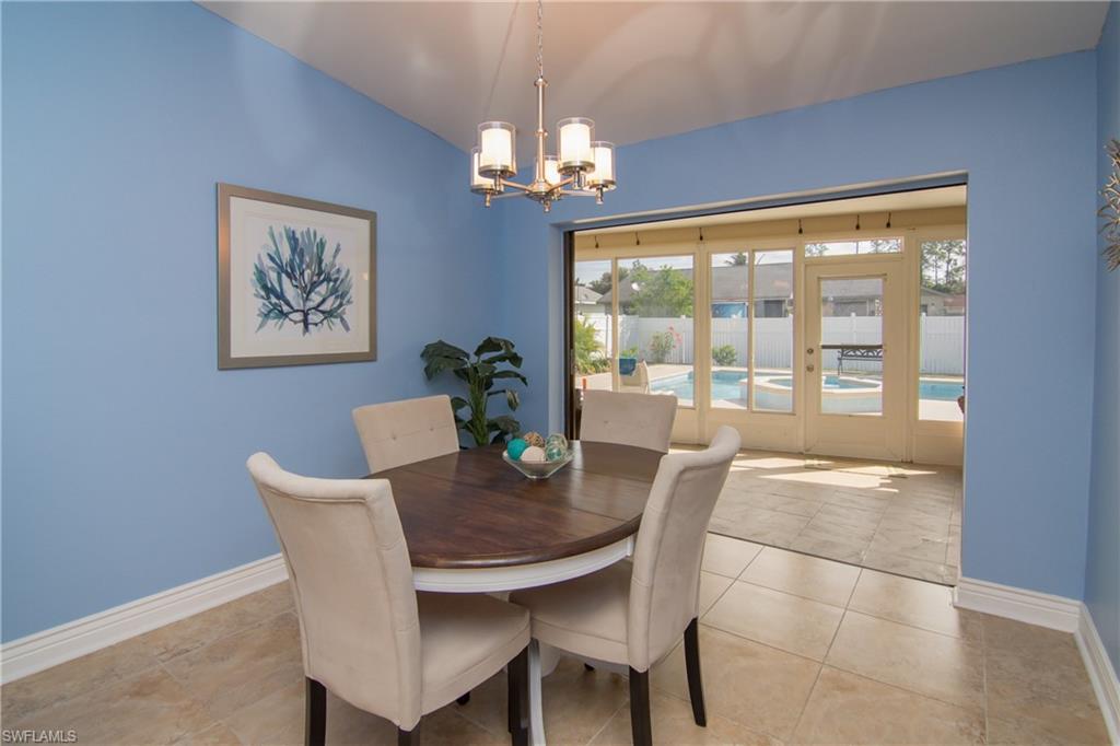 17453 Lebanon Road Fort Myers, FL 33967 - Photo 8 of 29 a dining room with furniture a large window and a chandelier