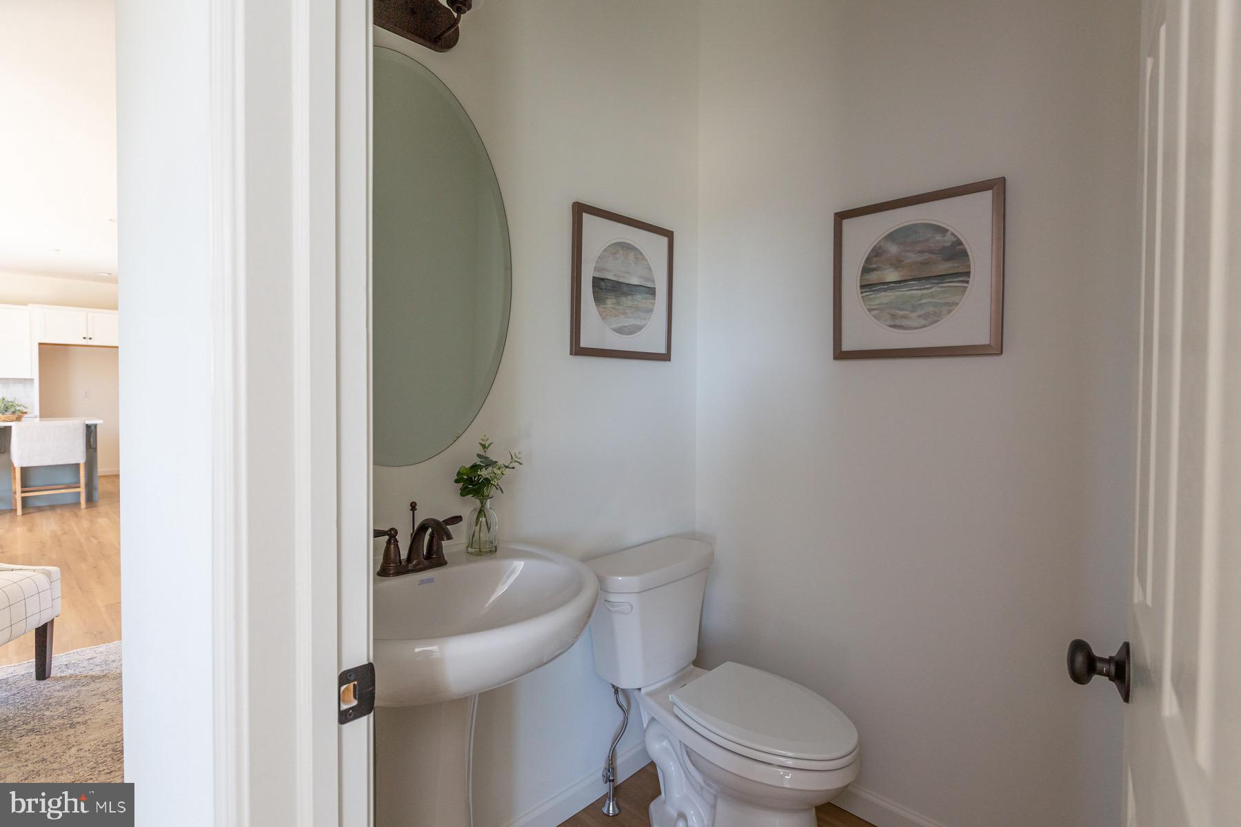 306 Wickmere Street, Unit 68 Oxford, PA 19363 - Photo 18 of 40 a white toilet sitting next to a bathroom sink