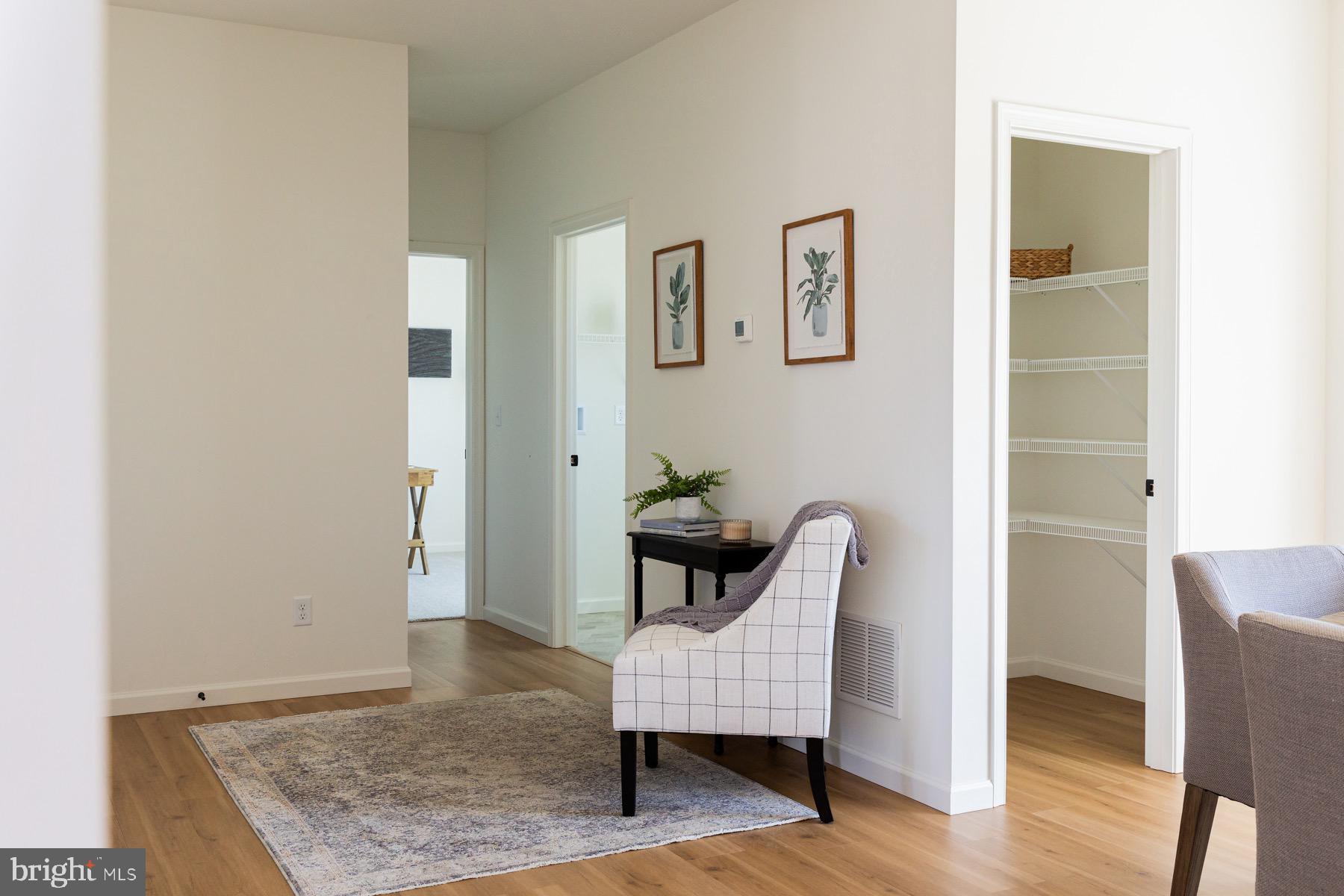 306 Wickmere Street, Unit 68 Oxford, PA 19363 - Photo 20 of 40 a view of a hallway with wooden floor and furniture