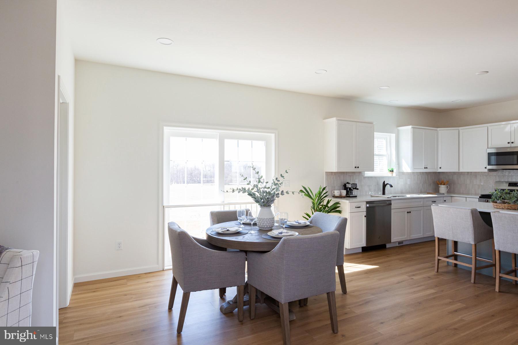 306 Wickmere Street, Unit 68 Oxford, PA 19363 - Photo 21 of 40 a view of a dining room with furniture and wooden floor