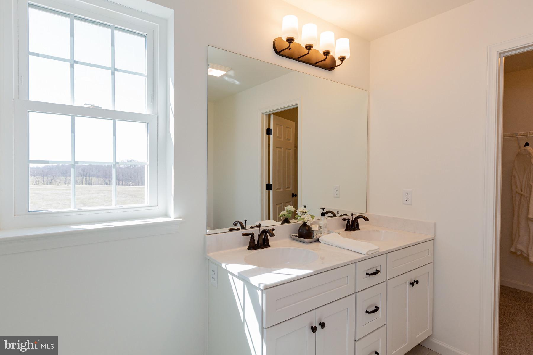 306 Wickmere Street, Unit 68 Oxford, PA 19363 - Photo 26 of 40 a bathroom with a sink and a mirror