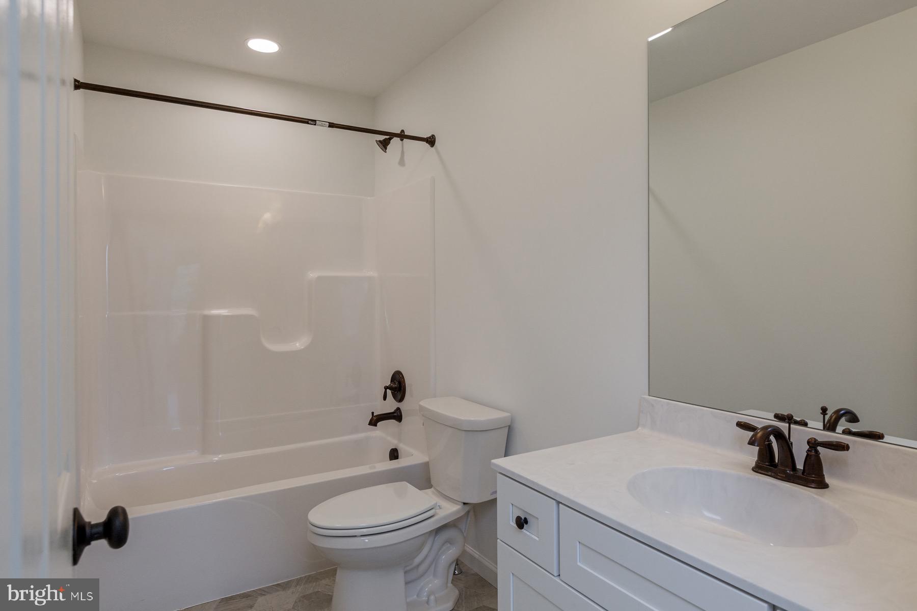 306 Wickmere Street, Unit 68 Oxford, PA 19363 - Photo 31 of 40 a bathroom with a sink a toilet and shower