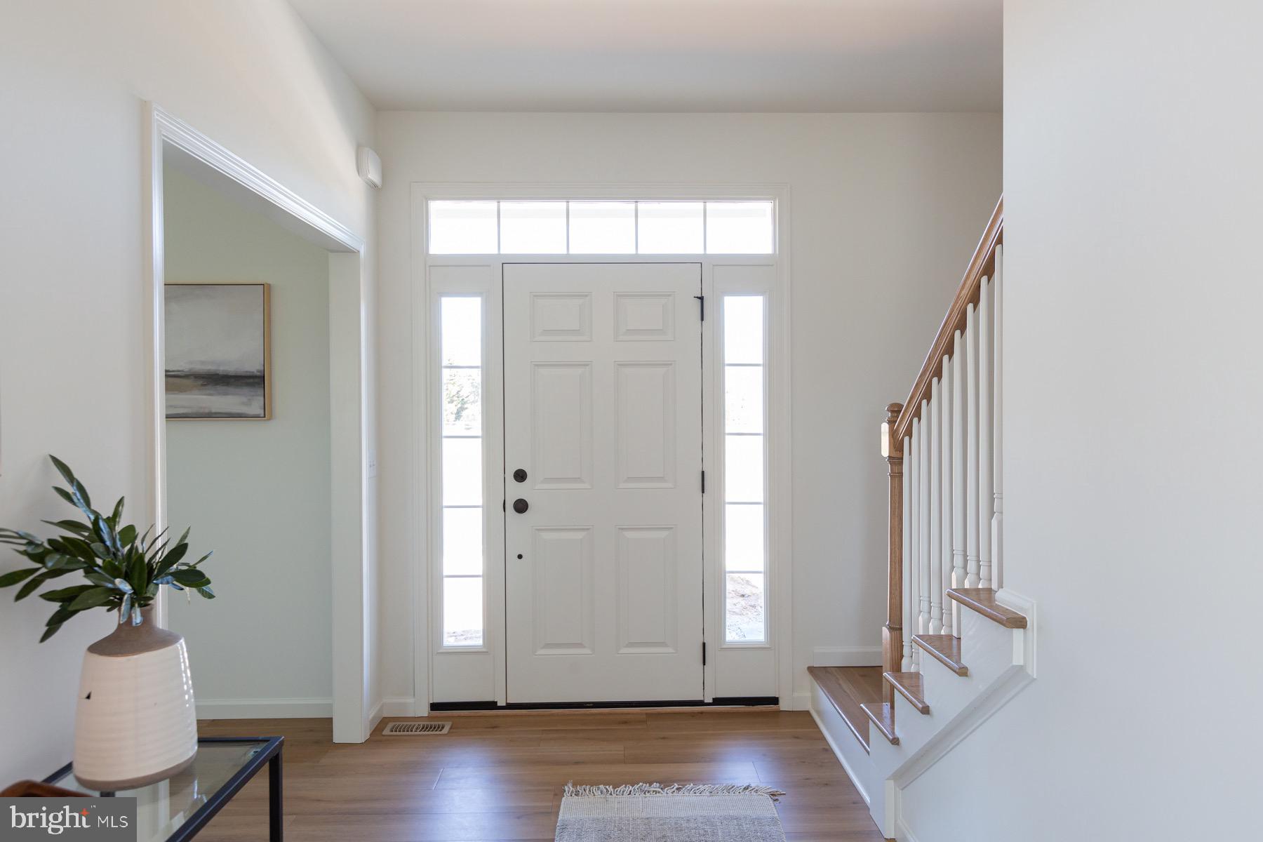 306 Wickmere Street, Unit 68 Oxford, PA 19363 - Photo 4 of 40 a view of a hallway with wooden floor and glass door