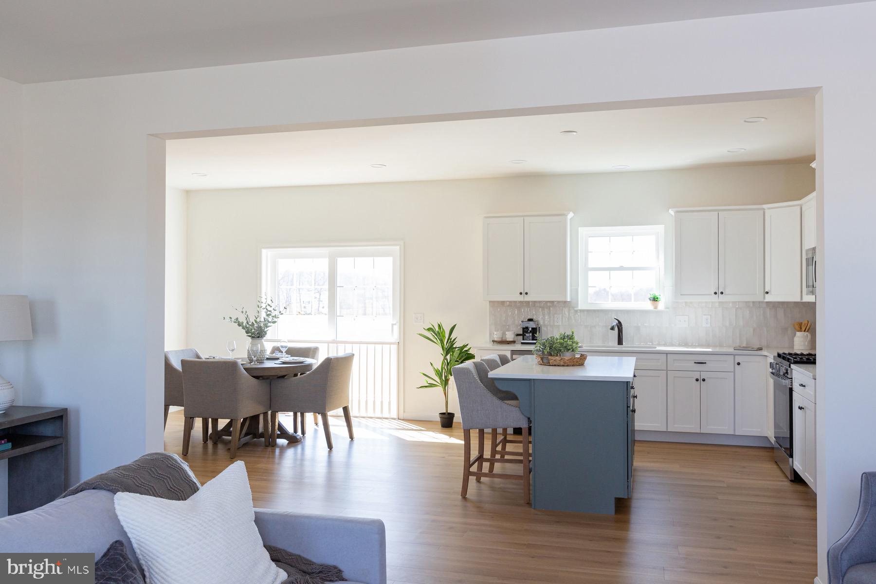 306 Wickmere Street, Unit 68 Oxford, PA 19363 - Photo 7 of 40 a view of a dining room with furniture and wooden floor