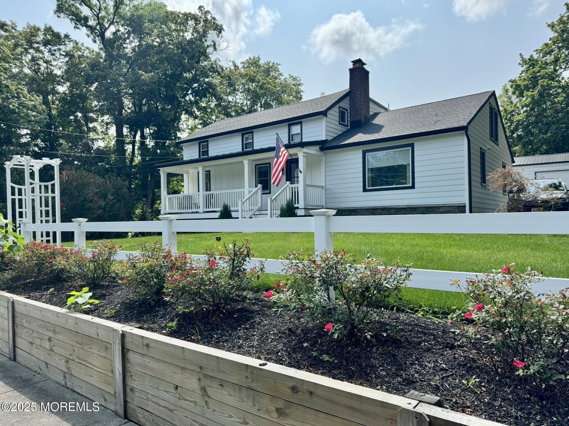 72 Main Street Holmdel, NJ 07733 - Photo 1 of 45 a front view of a house with a yard and fountain