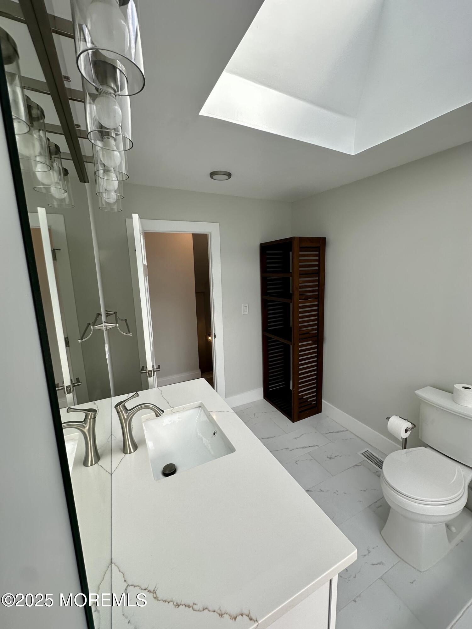 72 Main Street Holmdel, NJ 07733 - Photo 13 of 45 a bathroom with a sink a toilet and shower