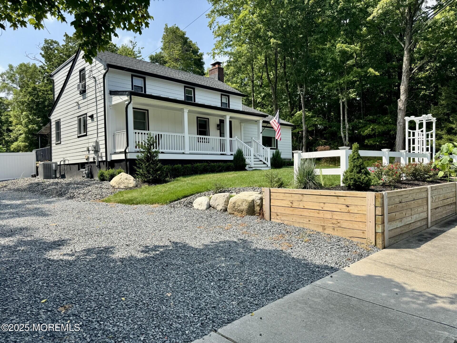 72 Main Street Holmdel, NJ 07733 - Photo 14 of 45 a front view of a house with garden