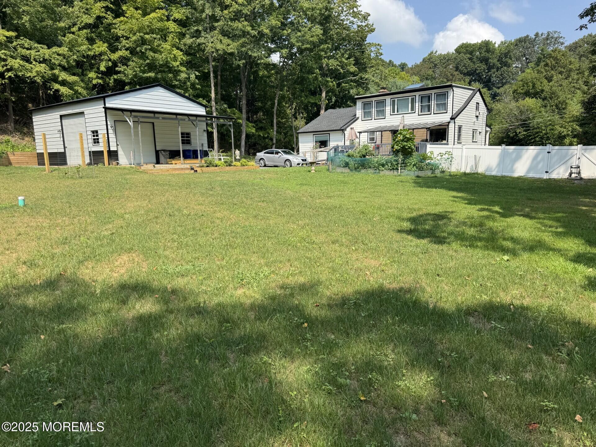 72 Main Street Holmdel, NJ 07733 - Photo 2 of 45 a white house with a big yard and large trees