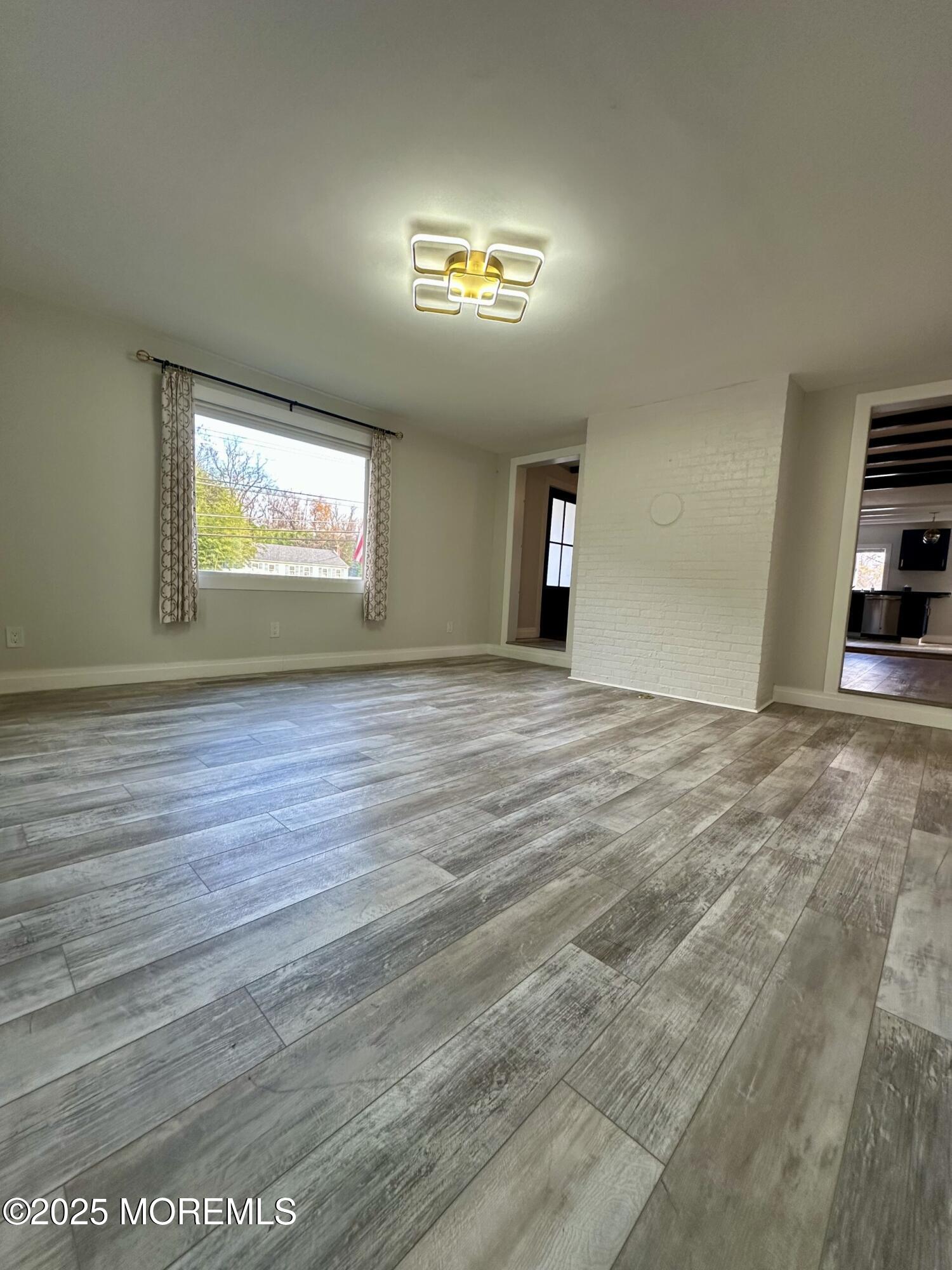 72 Main Street Holmdel, NJ 07733 - Photo 25 of 45 a view of an empty room with window and fireplace
