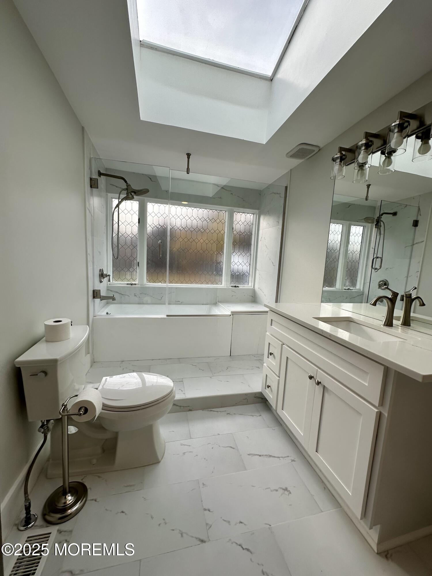 72 Main Street Holmdel, NJ 07733 - Photo 31 of 45 a bathroom with a toilet sink and mirror