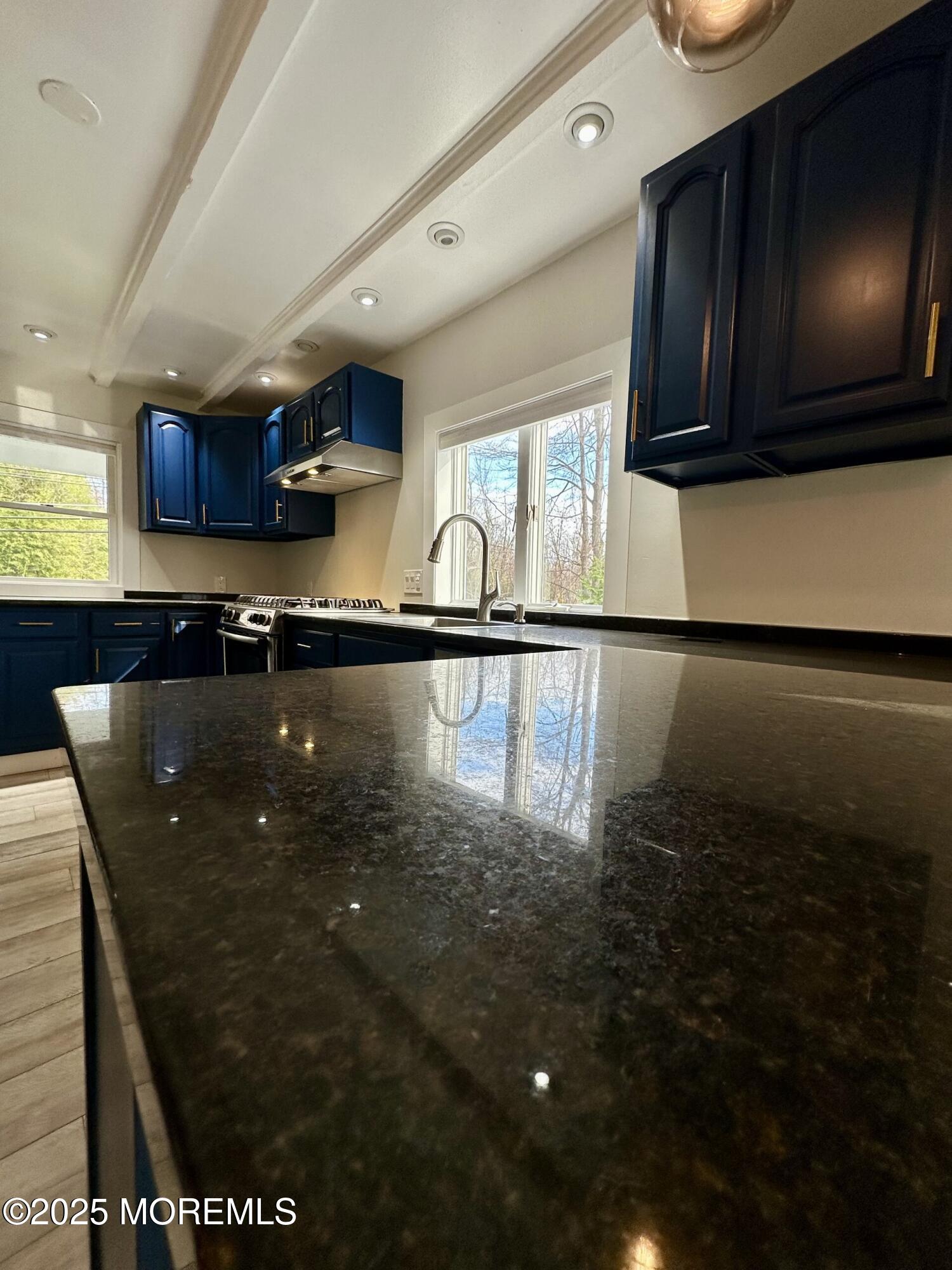 72 Main Street Holmdel, NJ 07733 - Photo 5 of 45 a kitchen with stainless steel appliances granite countertop a stove a sink and a microwave