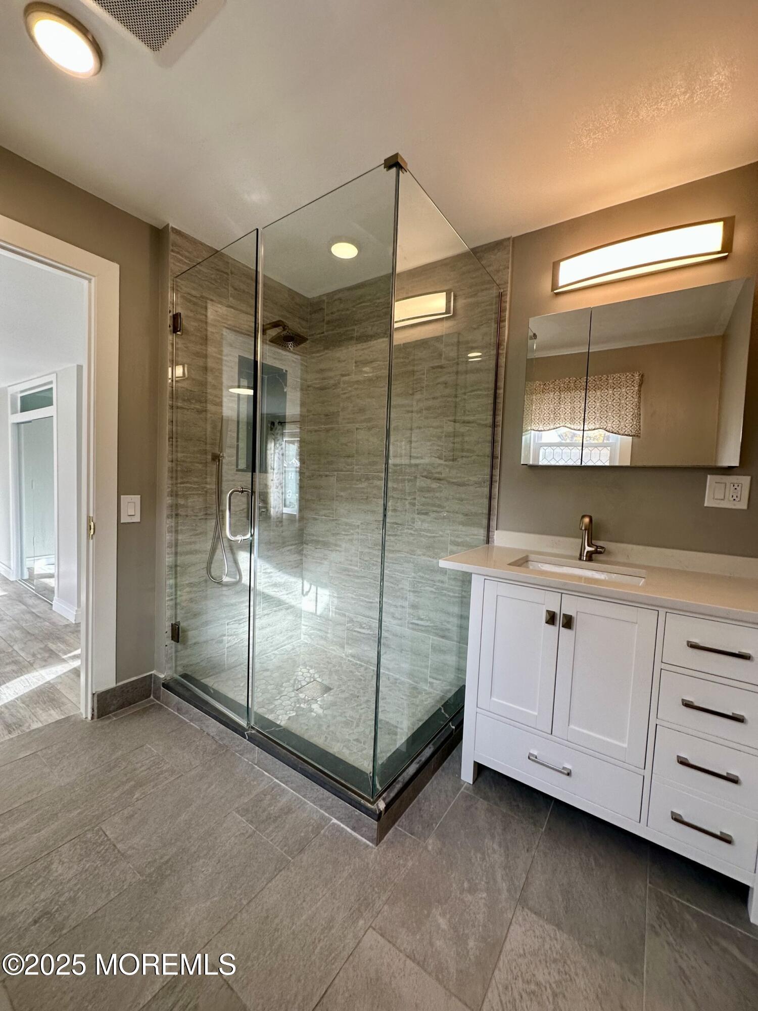 72 Main Street Holmdel, NJ 07733 - Photo 10 of 45 a bathroom with a shower and a sink mirror