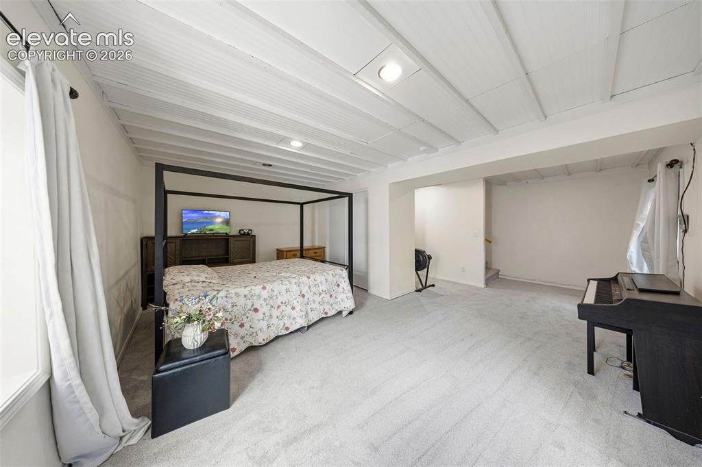 13075 Blaney Road South Peyton, CO 80831 - Photo 19 of 40 Spacious basement bedroom featuring new light-toned carpeting and a white planked ceiling with recessed lighting