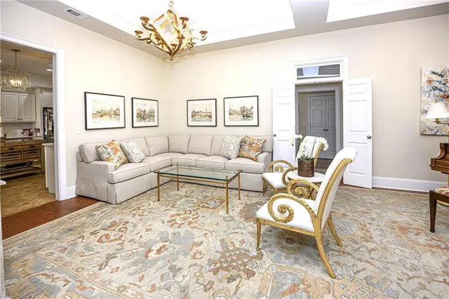 a living room with furniture and a chandelier