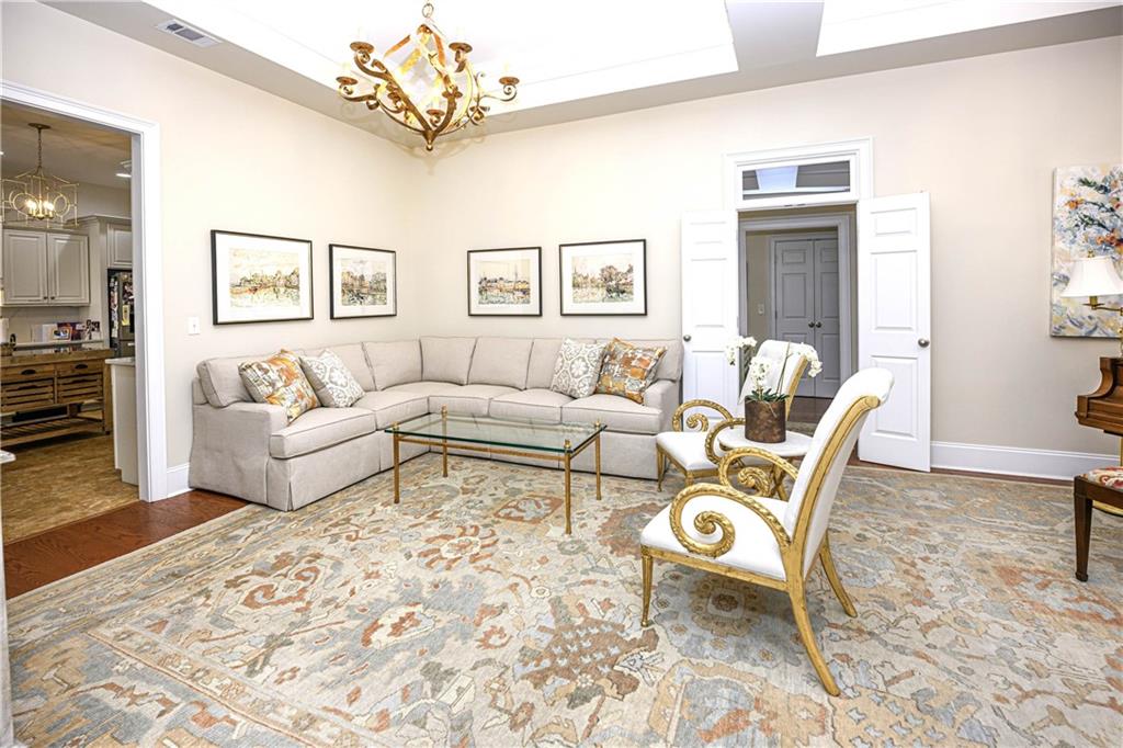 902 Quail Ridge Lane Perry, GA 31069 - Photo 12 of 25 a living room with furniture and a chandelier