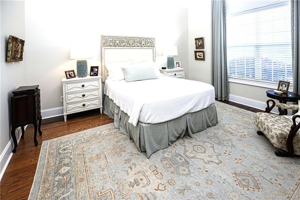 902 Quail Ridge Lane Perry, GA 31069 - Photo 15 of 25 a spacious bedroom with a bed a couch and large window