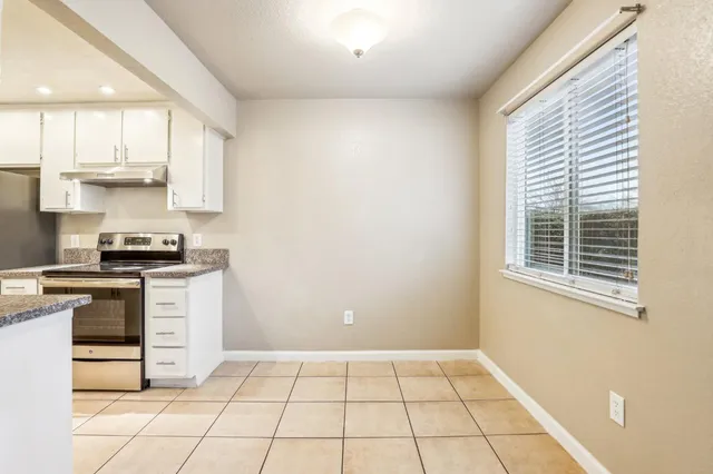 a kitchen with a stove a sink and a microwave