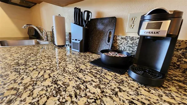 a view of a refrigerator and wooden floor