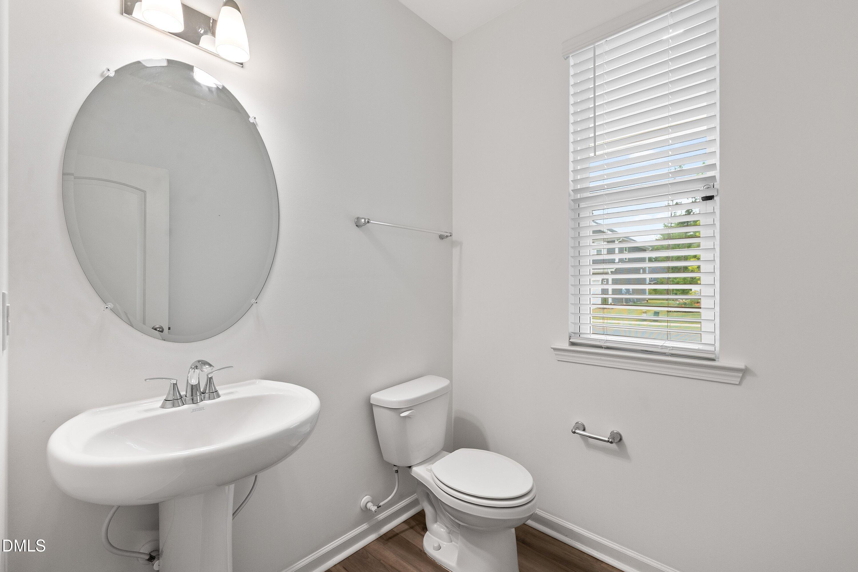 2129 Crestwood Rdg Drive Durham, NC 27704 - Photo 11 of 15 a bathroom with a sink toilet and a mirror