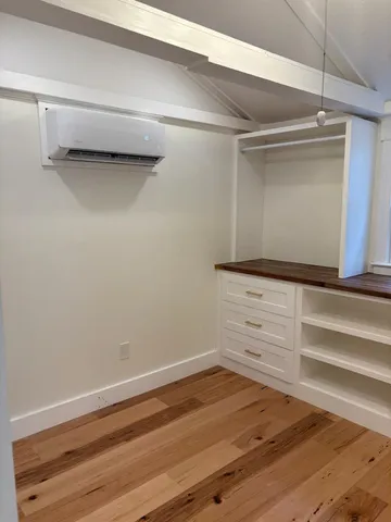 a view of walk in closet with empty racks