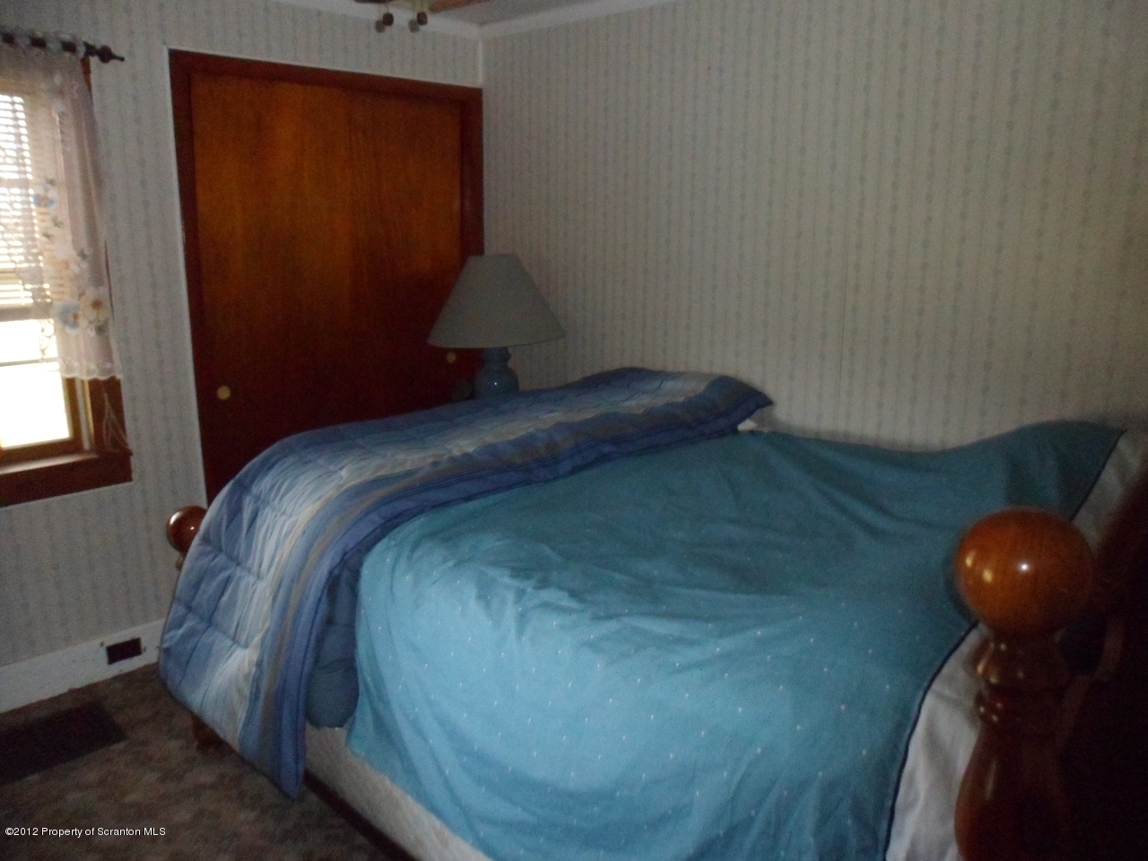437 North Baker Road Waymart, PA 18472 - Photo 6 of 22 a bed sitting in a bedroom next to a window
