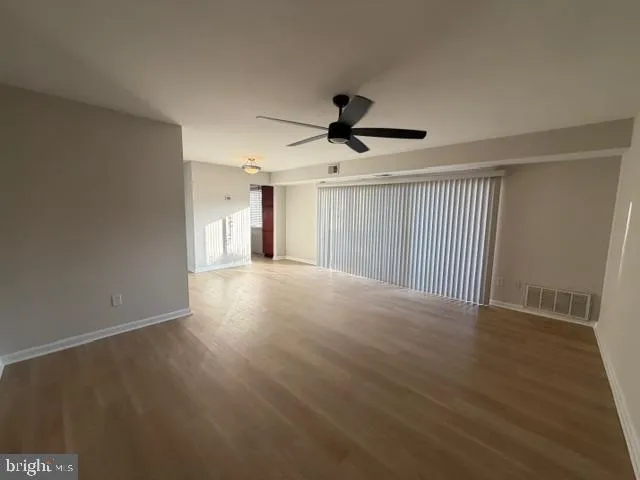 a view of a livingroom with a ceiling fan and window