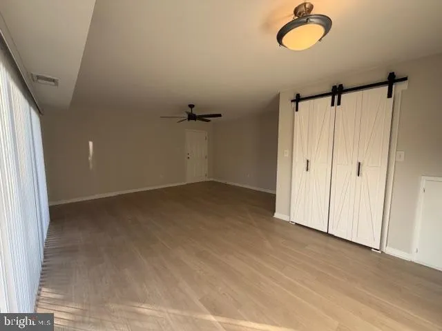 a view of a room with wooden floor and cabinet