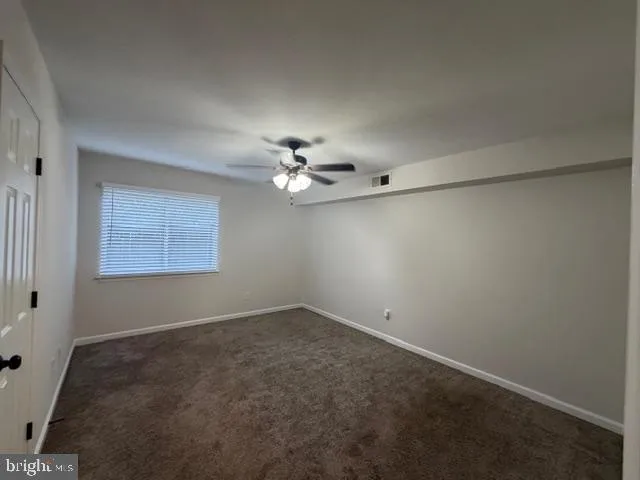 an empty room with a view of a bathroom