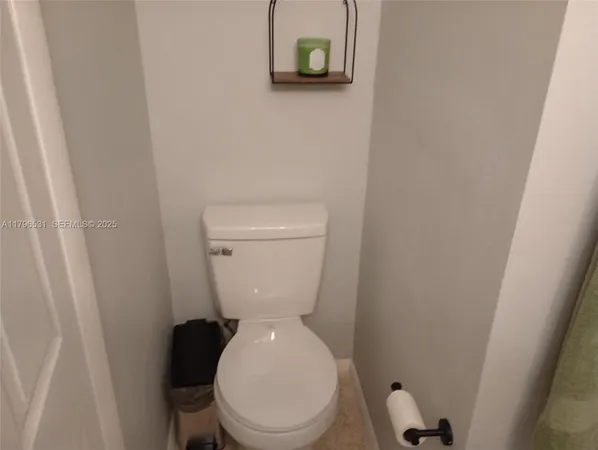 a white toilet sitting next to a small sink