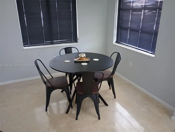 a view of a dining room with furniture and window