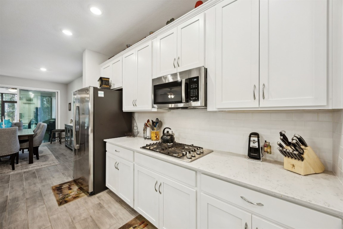 75505 Banyan Way Yulee, FL 32097 - Photo 16 of 94 a kitchen with stainless steel appliances granite countertop a refrigerator sink and microwave
