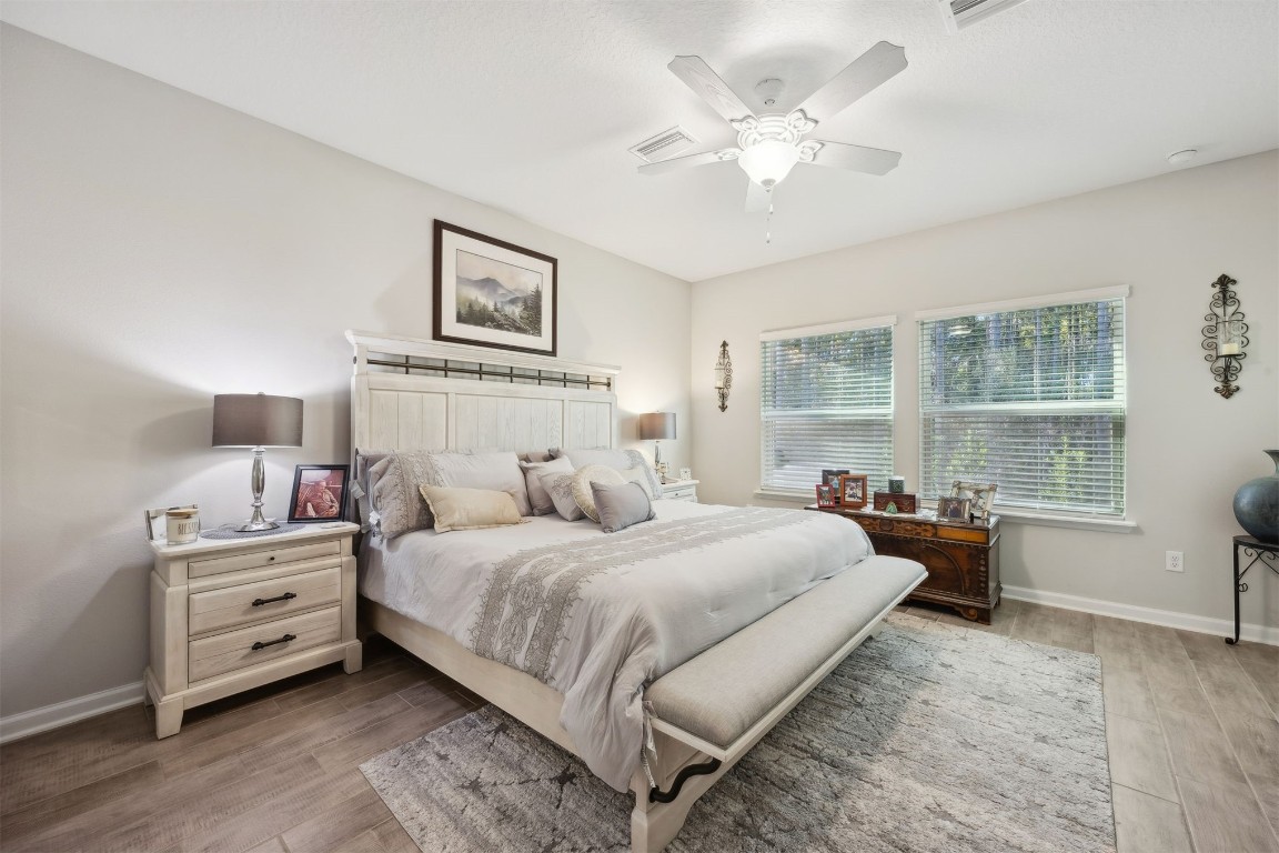 75505 Banyan Way Yulee, FL 32097 - Photo 23 of 94 a bedroom with a bed and a chandelier
