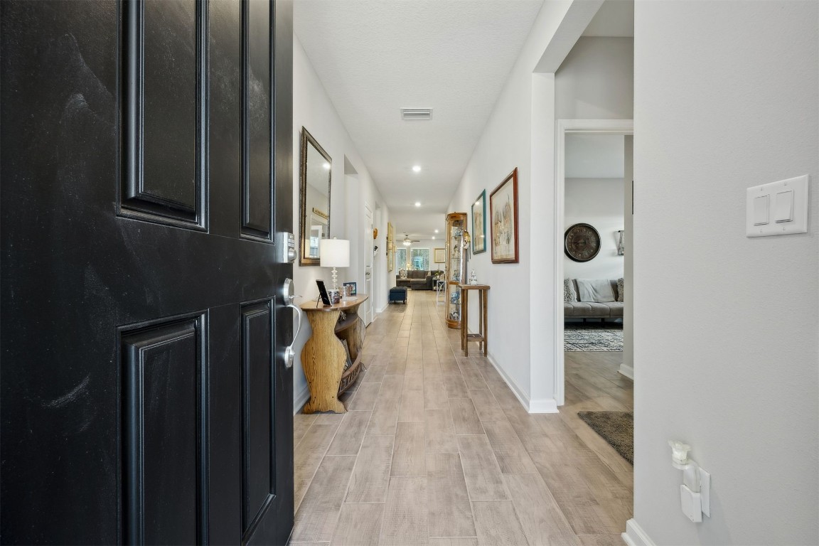 75505 Banyan Way Yulee, FL 32097 - Photo 5 of 94 a view of a hallway with wooden floor and a bathroom