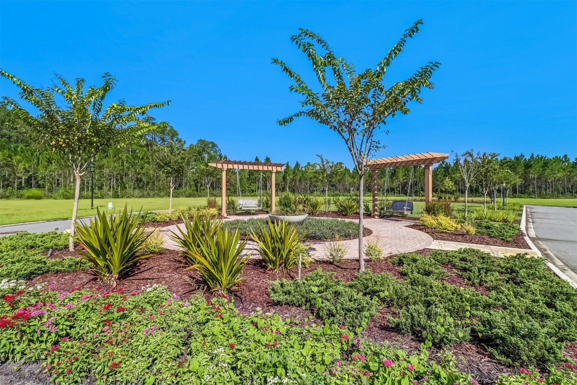 75505 Banyan Way Yulee, FL 32097 - Photo 59 of 94 a view of a garden with a bench