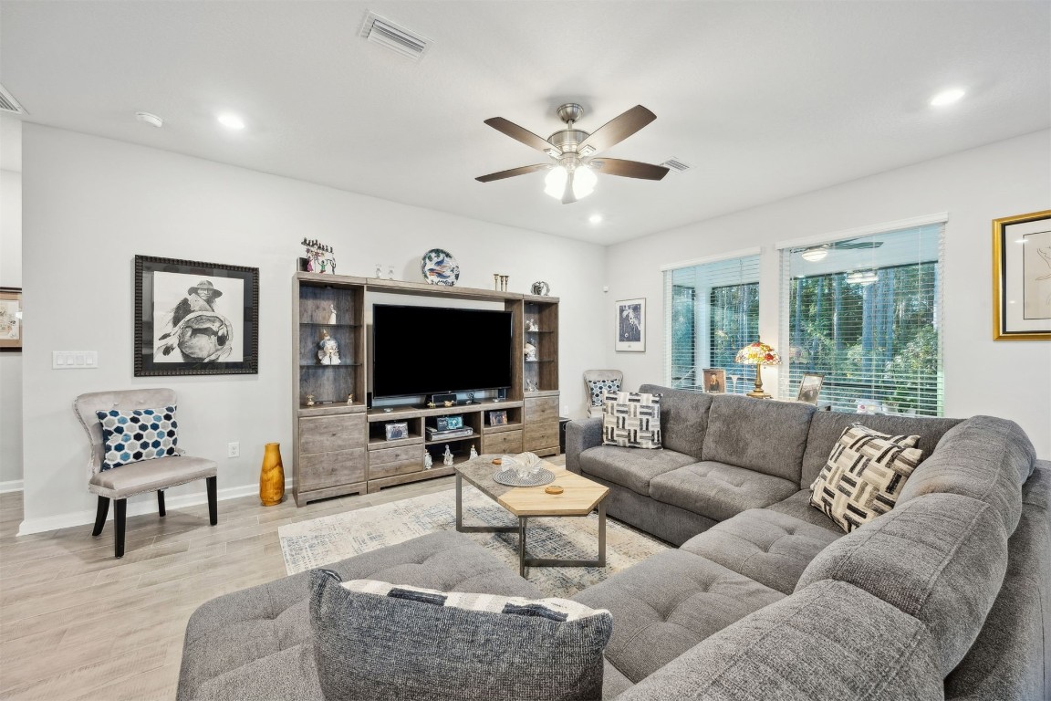 75505 Banyan Way Yulee, FL 32097 - Photo 9 of 94 a living room with furniture and a flat screen tv with wooden floor