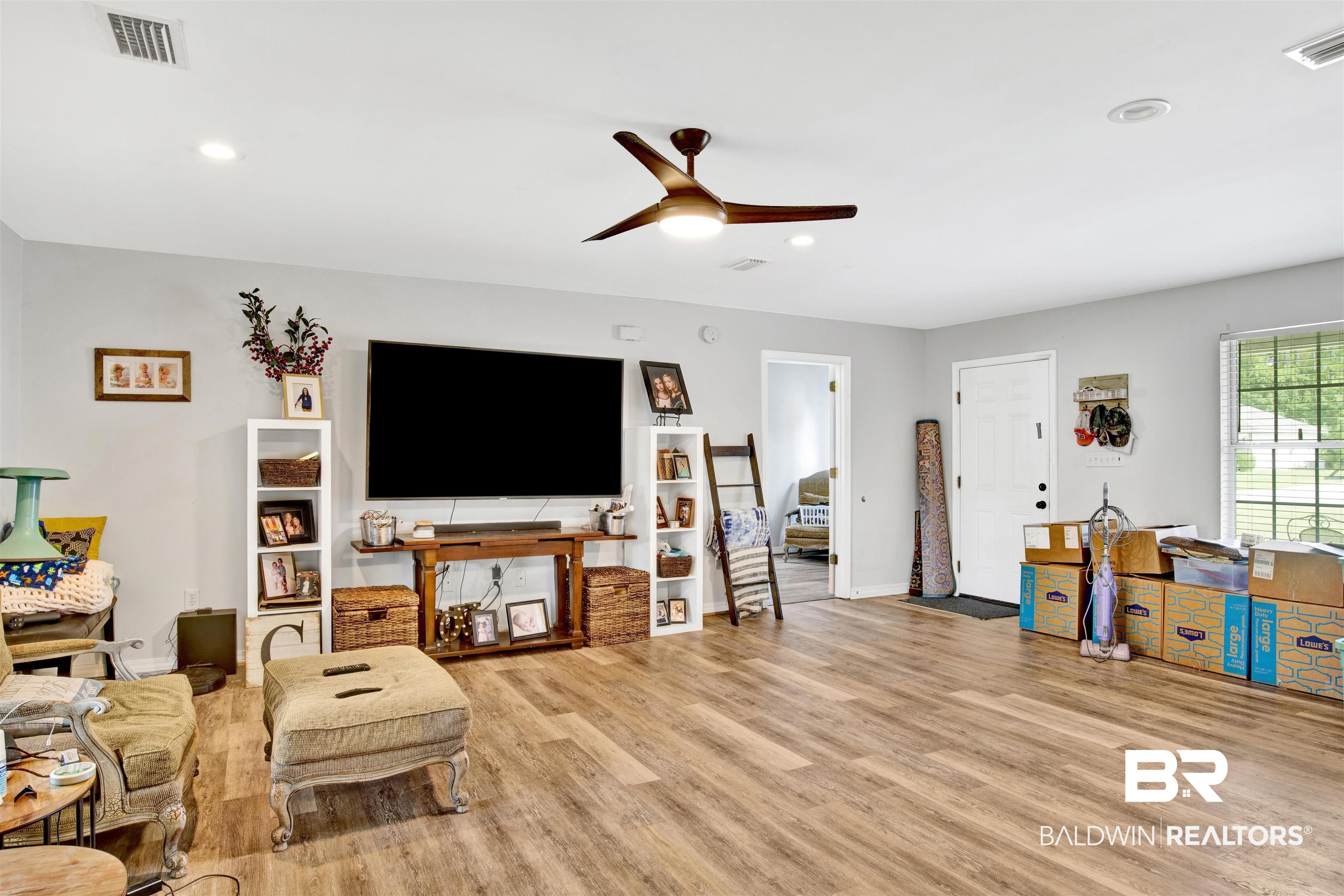 24384 Sailfish Lane Orange Beach, AL 36561 - Photo 5 of 23 Living room featuring ceiling fan and light hardwood / wood-style floors
