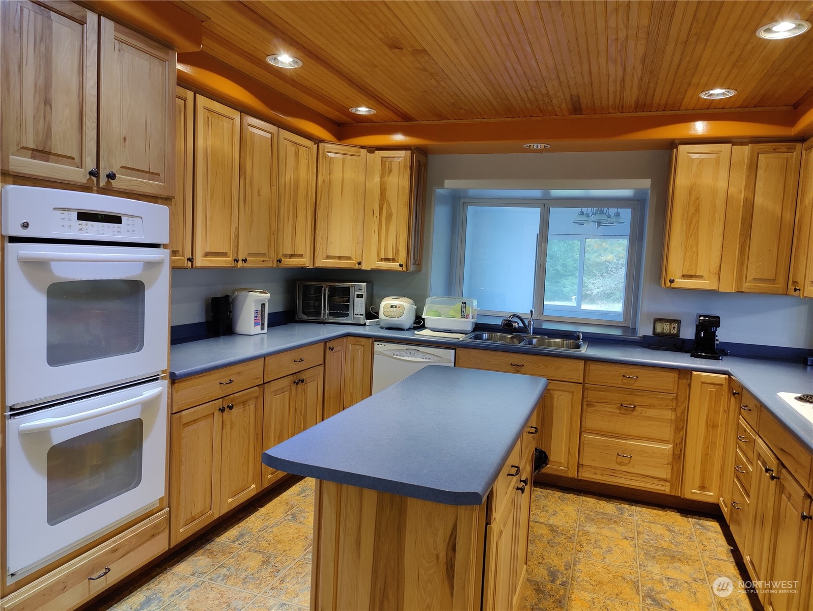 126 Reinseth Road Winlock, WA 98596 - Photo 11 of 33 a kitchen with stainless steel appliances granite countertop wooden cabinets a sink and dishwasher a stove with wooden floor